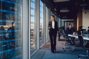 female executive with tablet walking through office